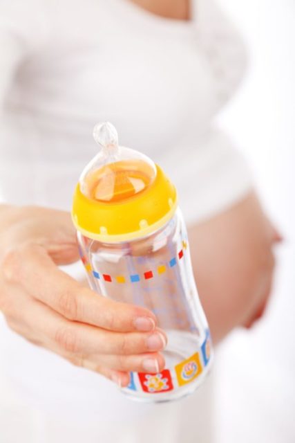 Pregnant woman with bottle